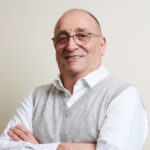 a headshot of dr len kliman with his arms crossed