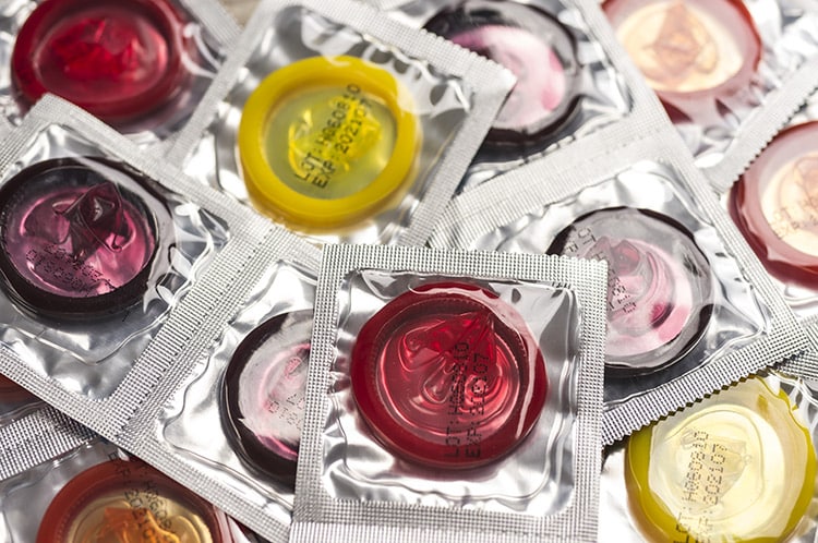 condom-packets a collection of different coloured condom packets
