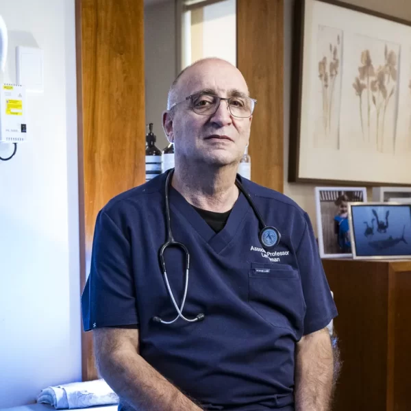 gynaecologist Dr Len kliman sitting on a treatment bed in his office