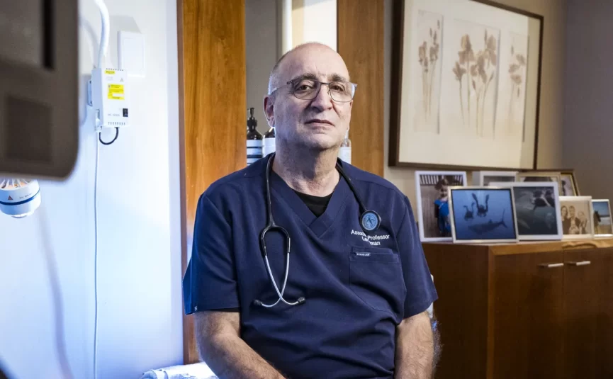 gynaecologist Dr Len kliman sitting on a treatment bed in his office